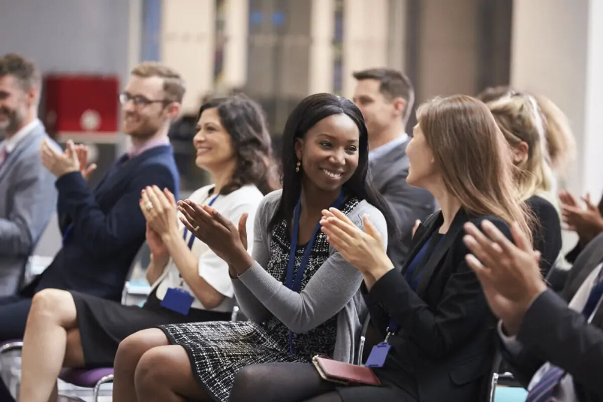 Businesspeople applauding at hospitality conference