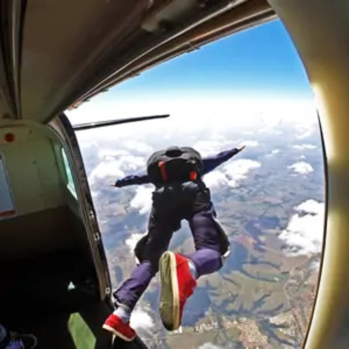 Man jumping out of plane to skydive