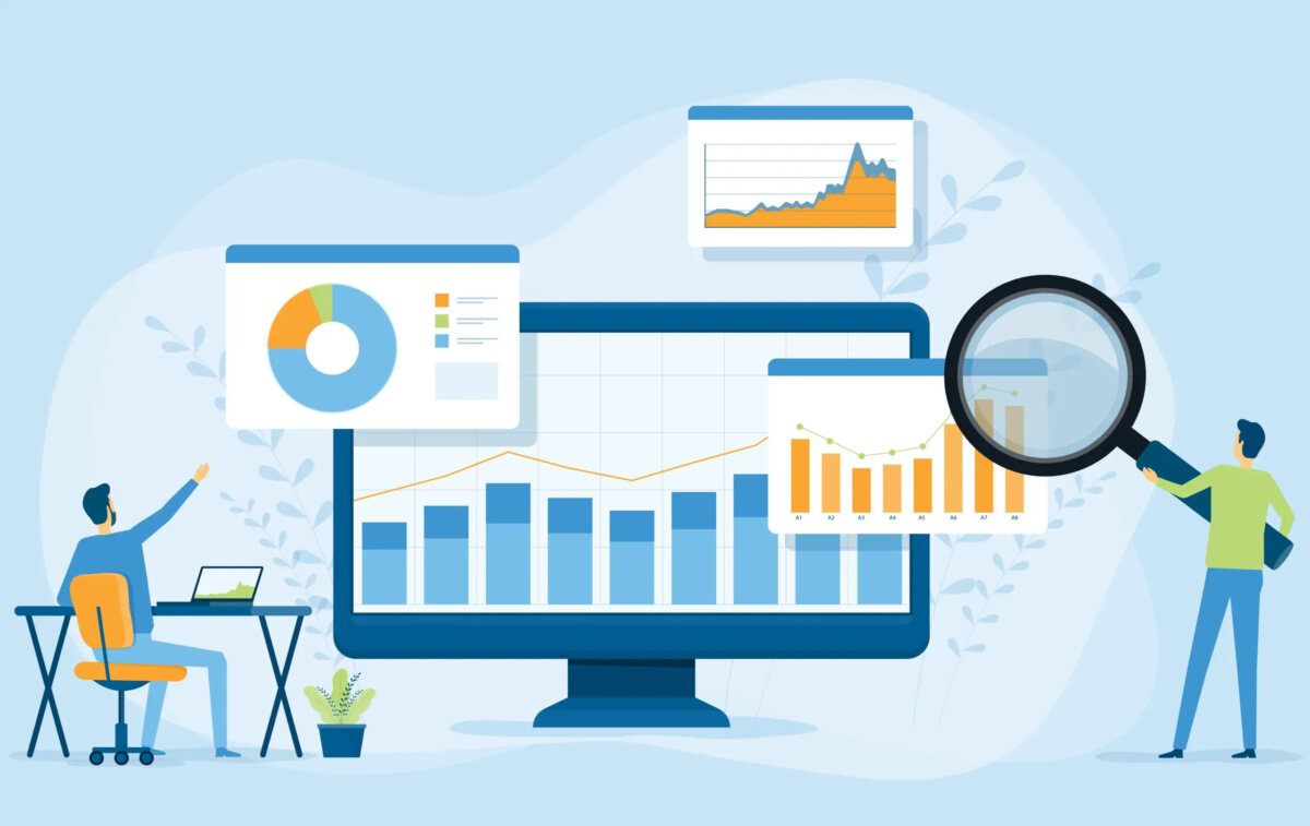 Cartoon of two miniature businessmen, one sitting at desk and one standing holding magnifying glass looking at computer screen and floating graphs and charts