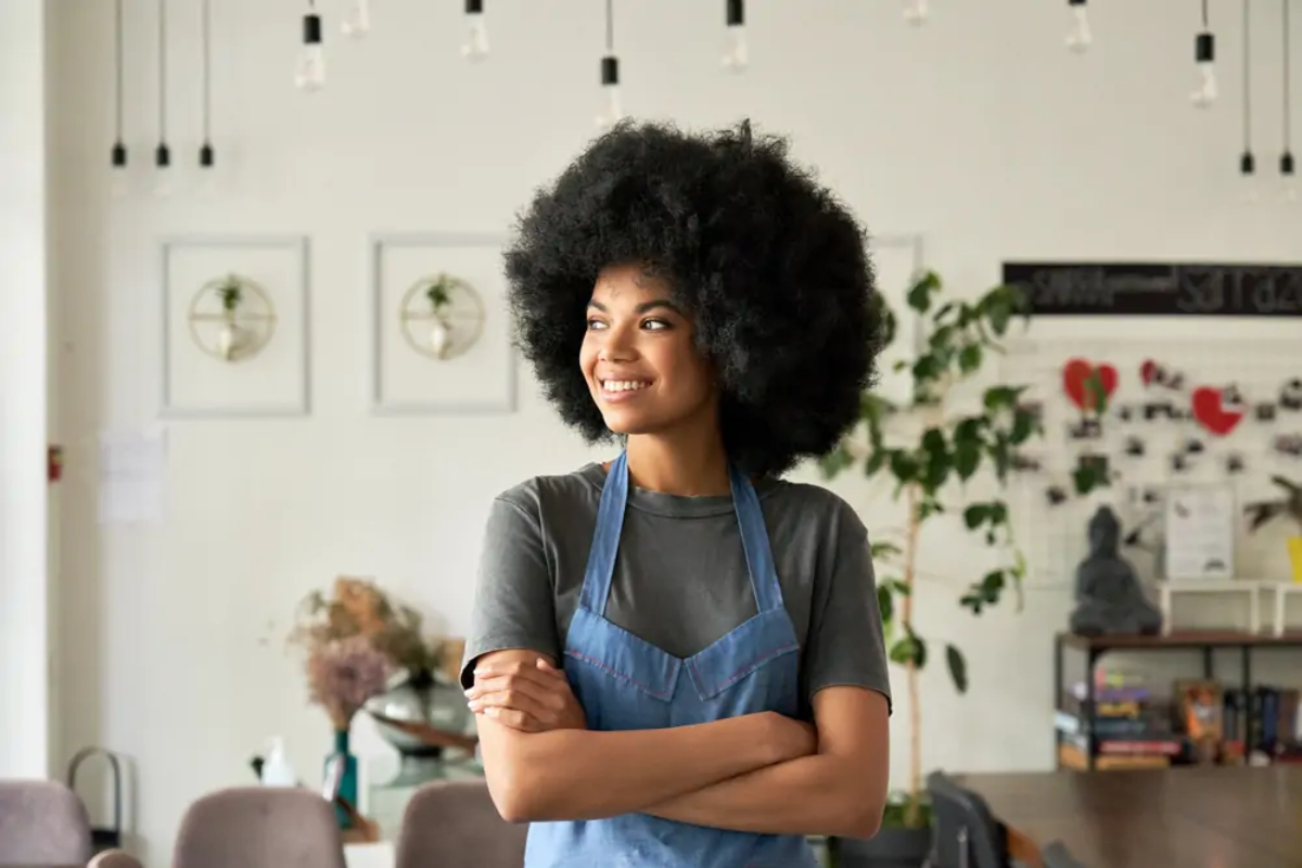 Hospitality worker standing in workplace smiling
