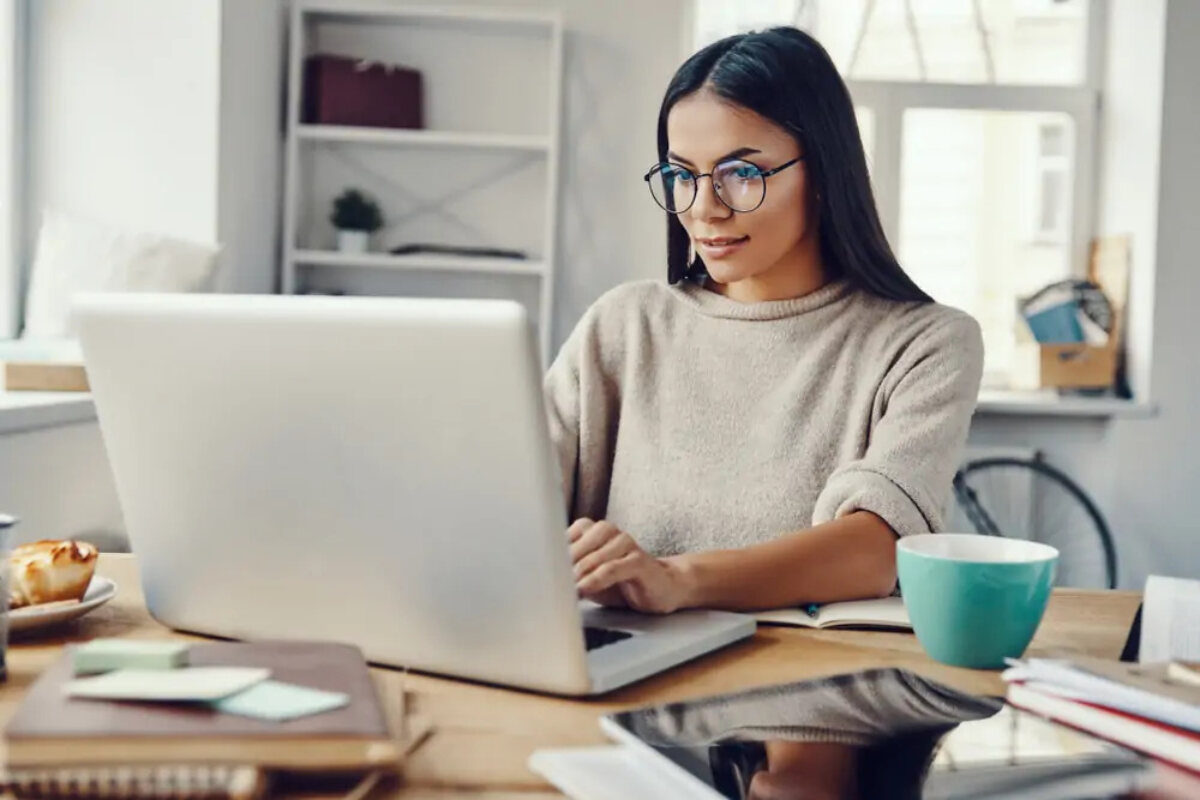 Businesswoman working from home on laptop at desk