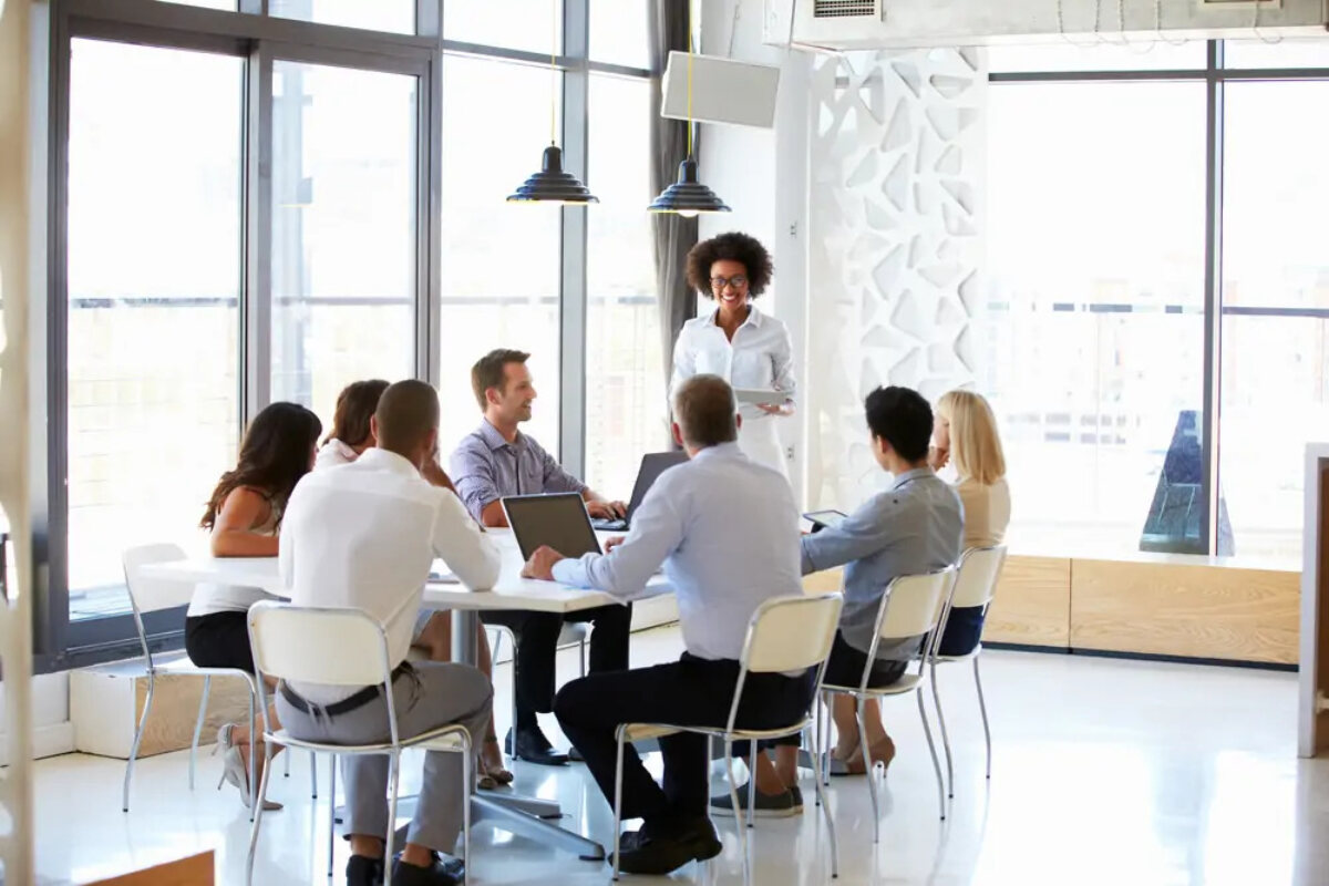 SME sat around table in business meeting