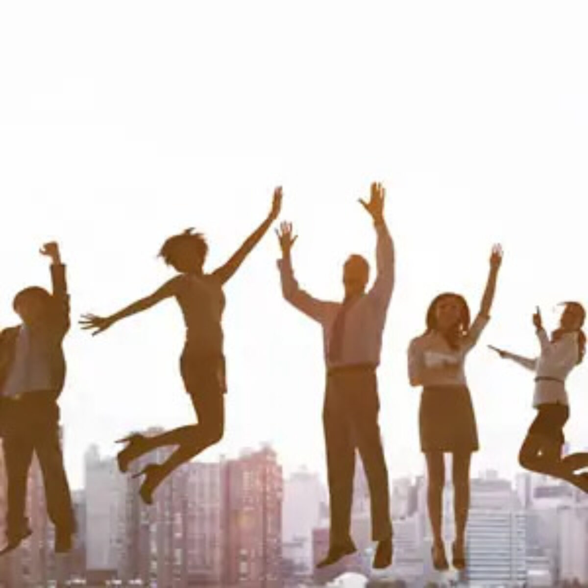 Five businesspeople jumping in celebration in front of cityscape background