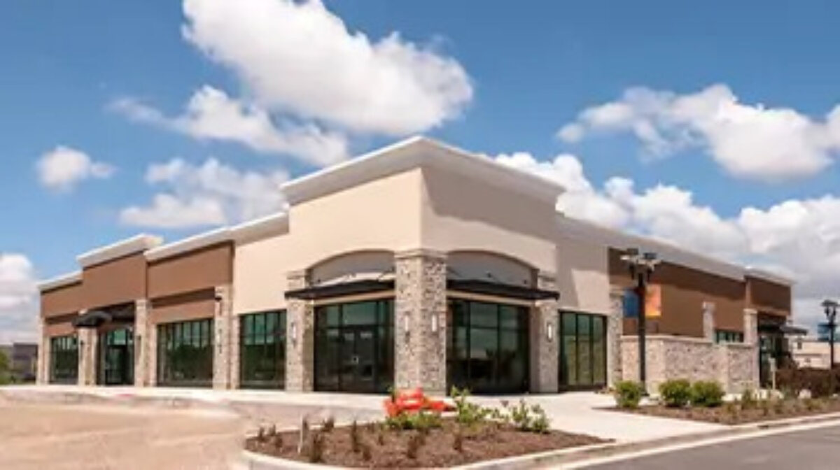 Large building with blue, cloudy sky above