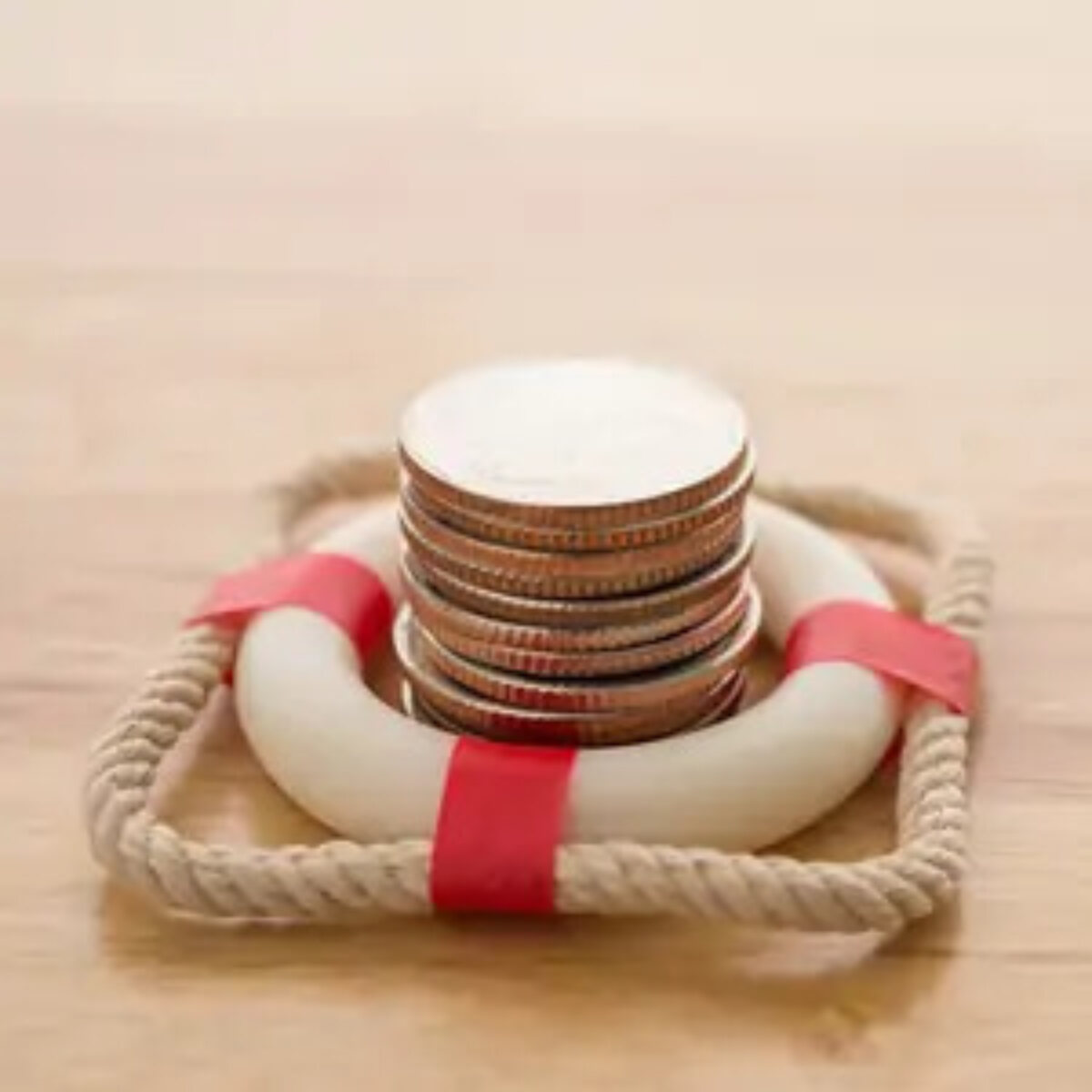 Stack of coins inside a miniature life ring