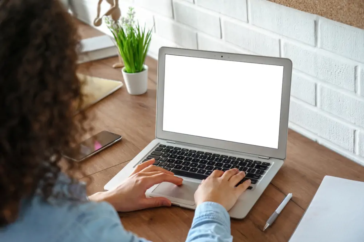 Businesswoman at desk working on laptop