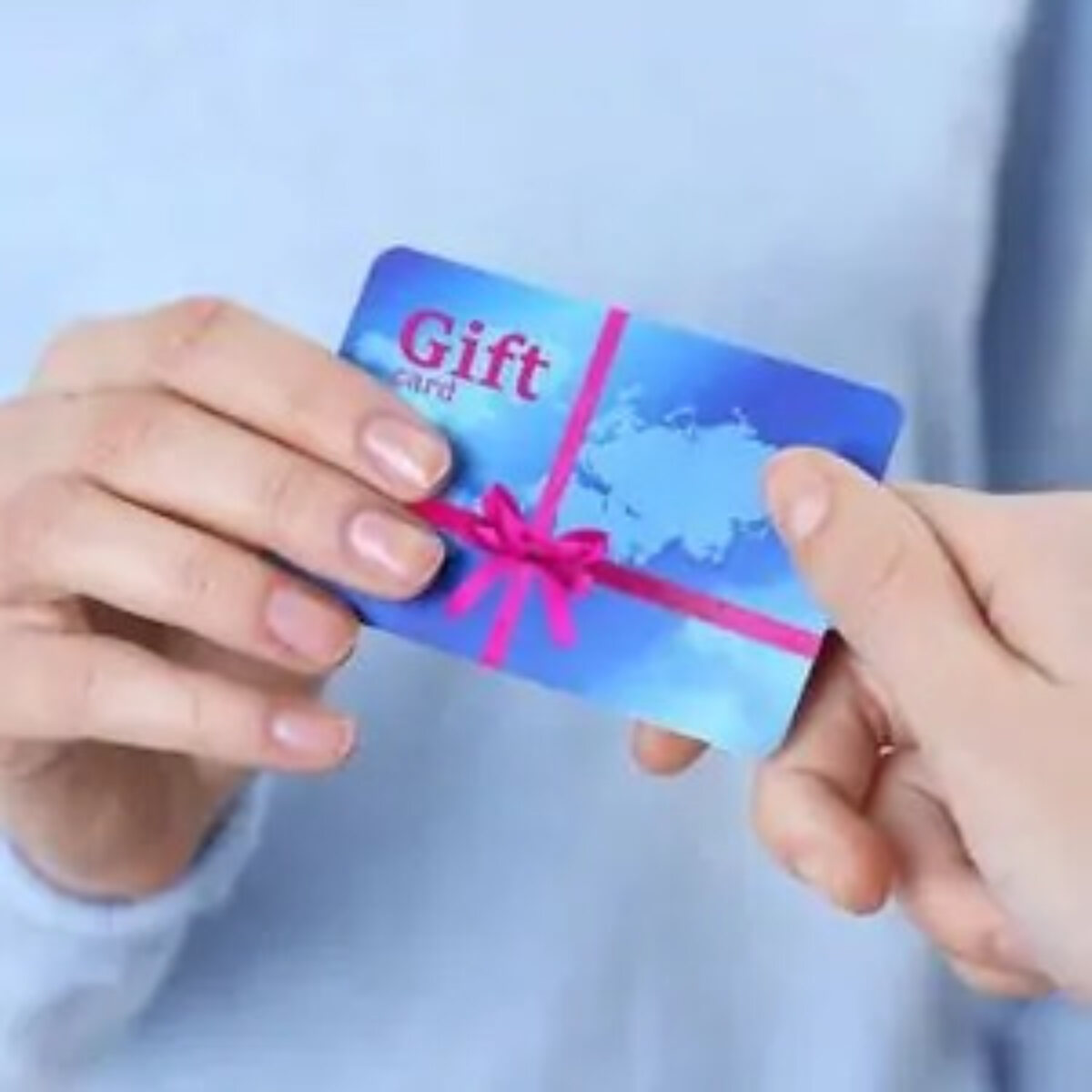 Gift card being handed over from one person to another