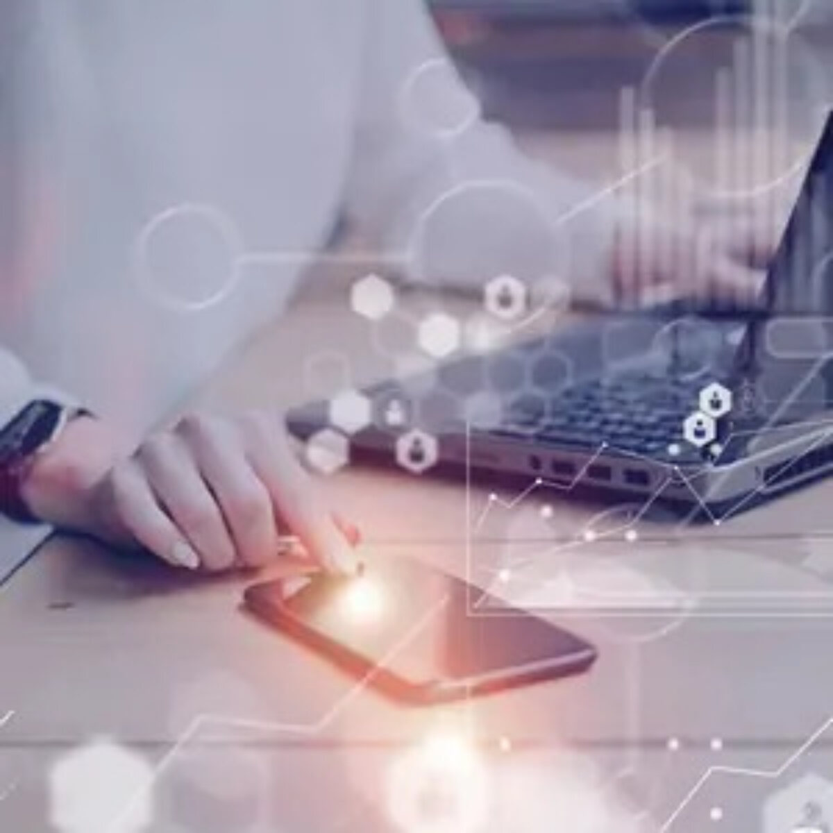 Businessperson using smartphone and laptop overlayed with technology graphics