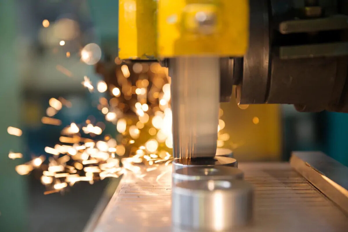 Close-up of metalwork machinery with sparks in background