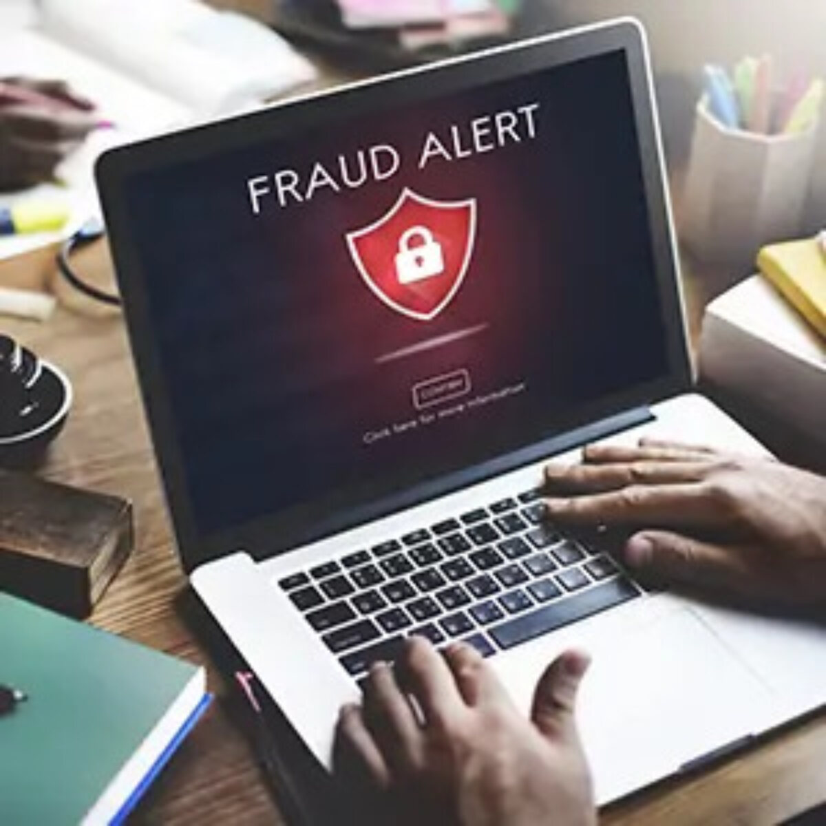 Laptop screen displaying 'fraud alert' warning