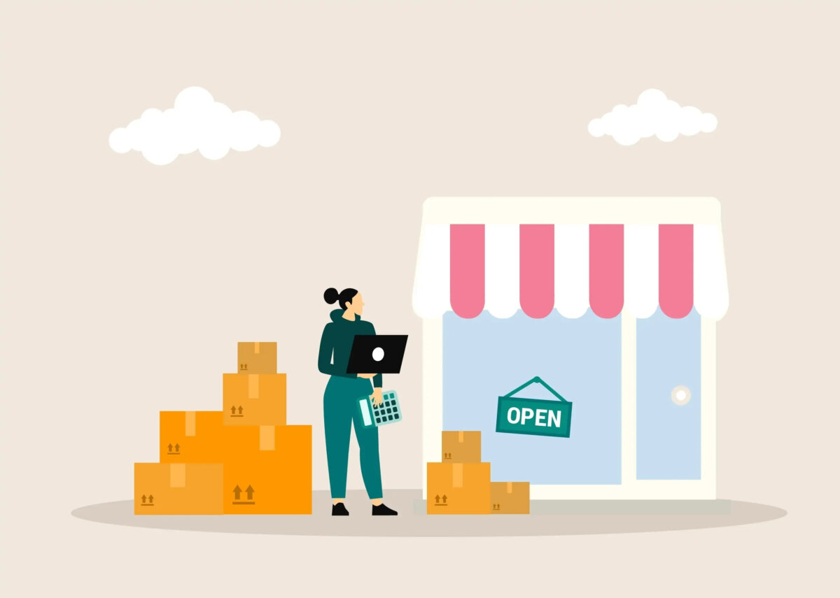 Cartoon of woman standing next to shopfront holding open laptop and calculator with a pile of cardboard boxes on either side of her