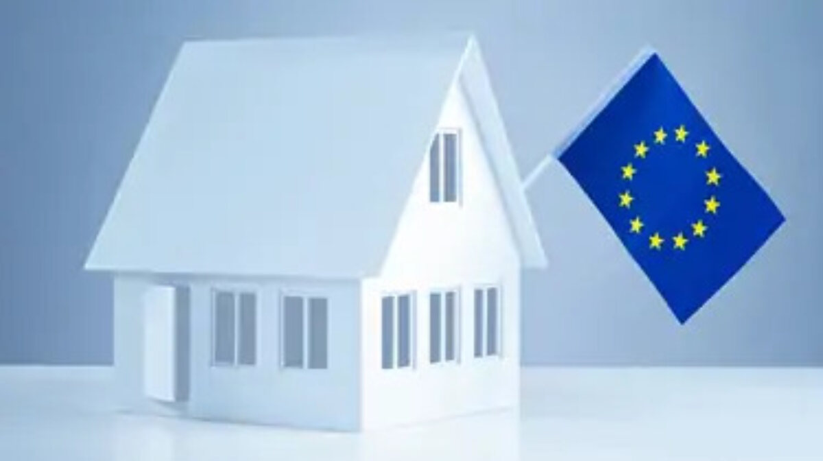 White 3D house with EU flag hanging from roof.
