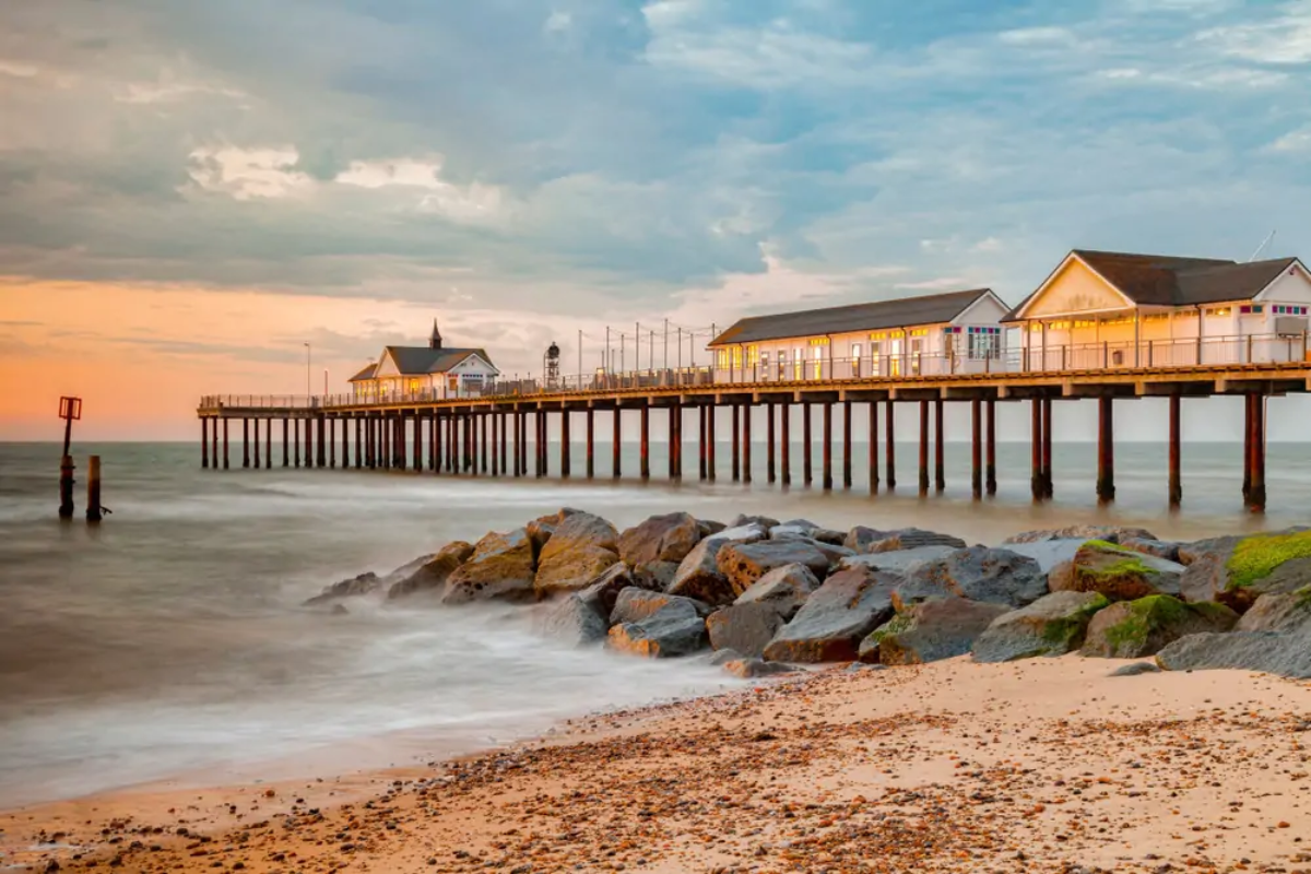 Three houses on pier at beach a sunset