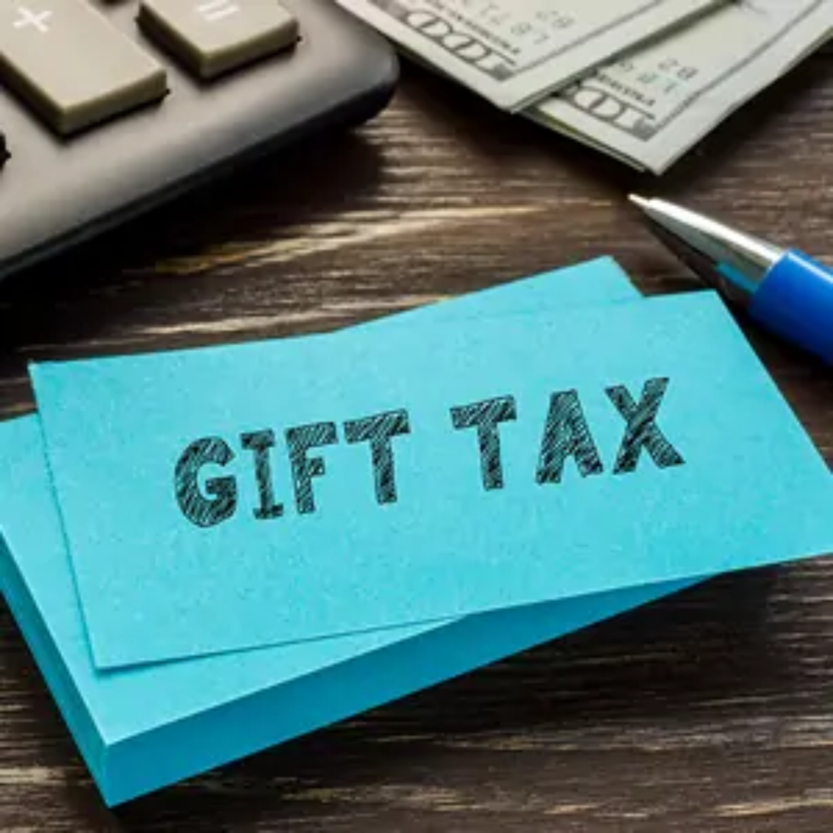 Post-it note on desk with 'gift tax' written on it