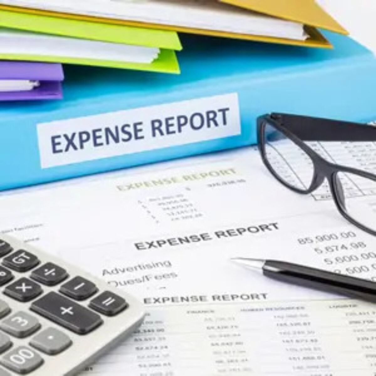 Expense report documents in front of a folder labelled 'expense report', with a pen, calculator and pair of glasses on top