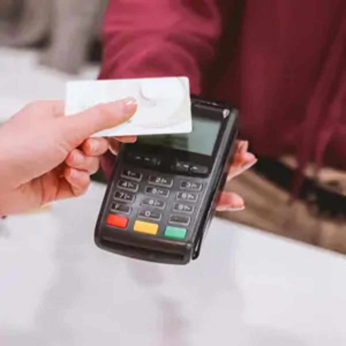 Person using card to pay contactless at card machine