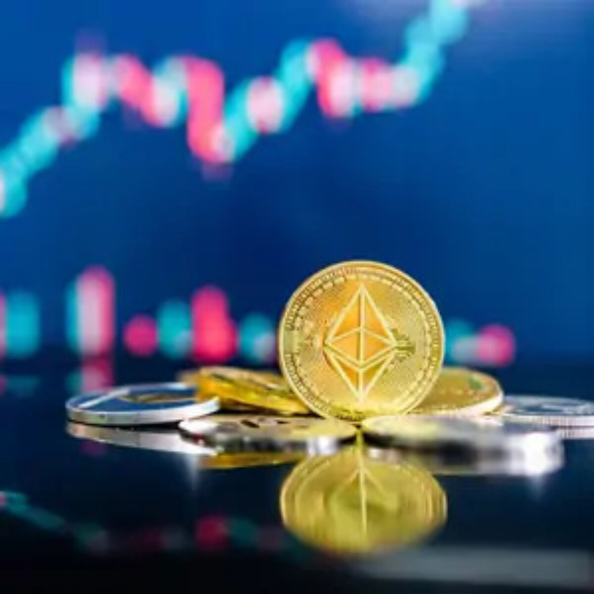 Crypto coin balanced on edge in front of pile of other crypto coins with crypto graph in background