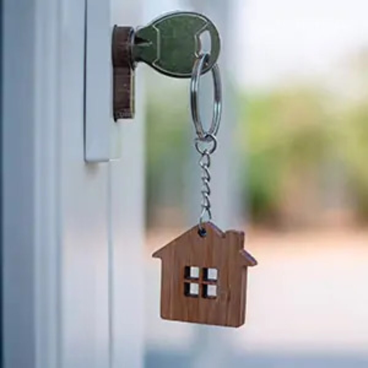 Key in door lock with house keyring attached