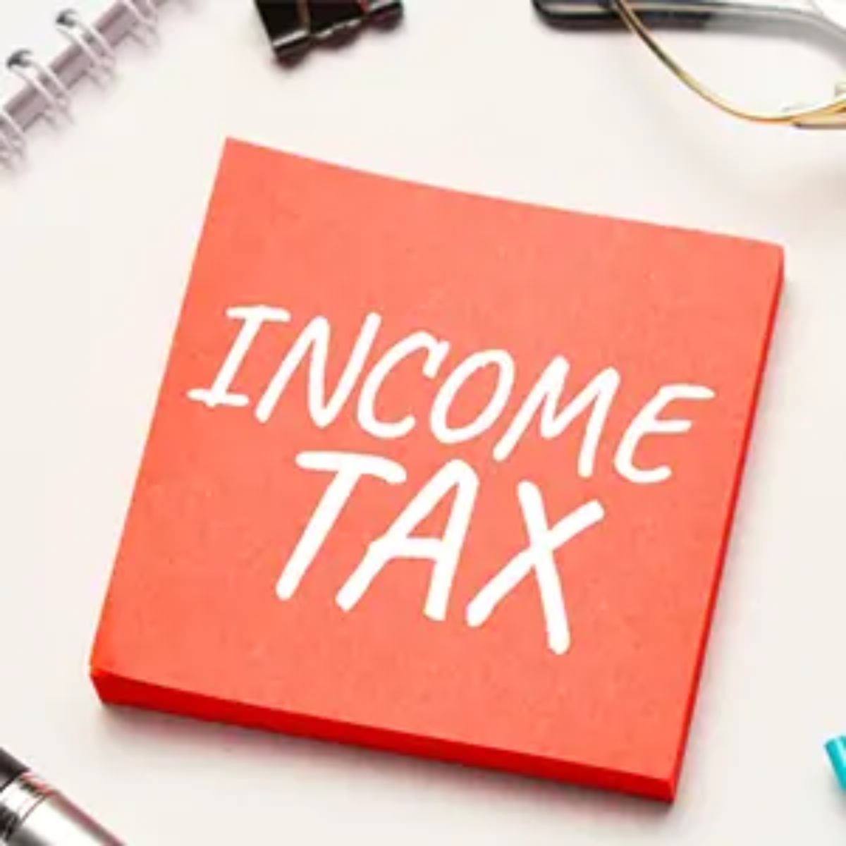 Post-it note with 'income tax' written on it