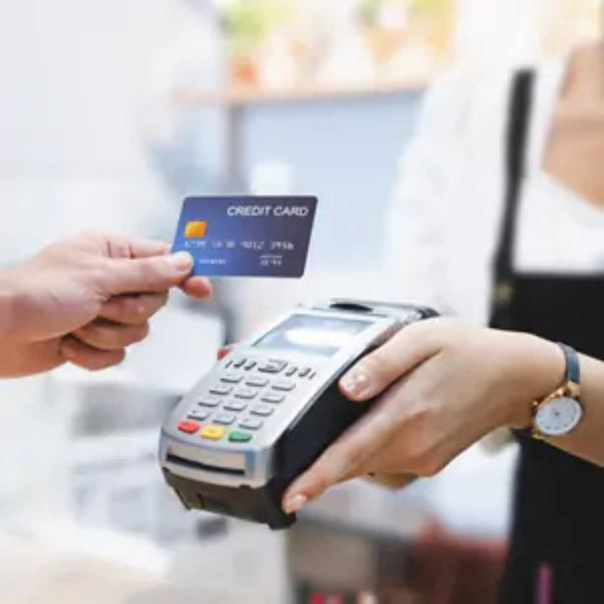 Customer using card to make contactless payment at card machine