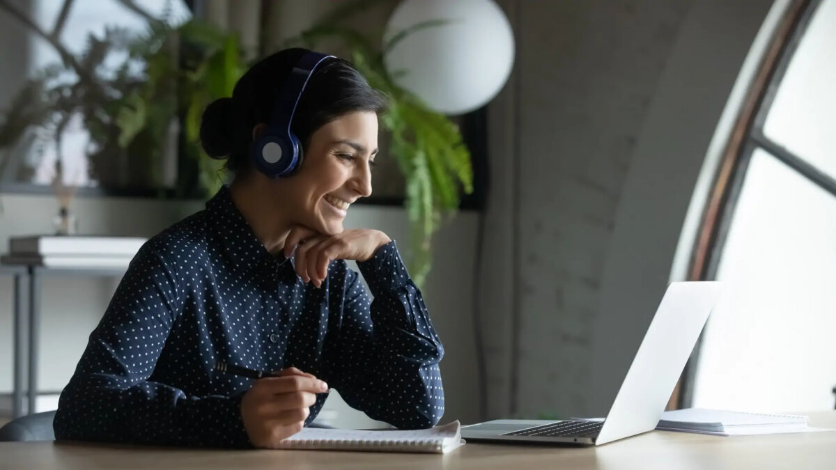 Businesswoman working on laptop with headset