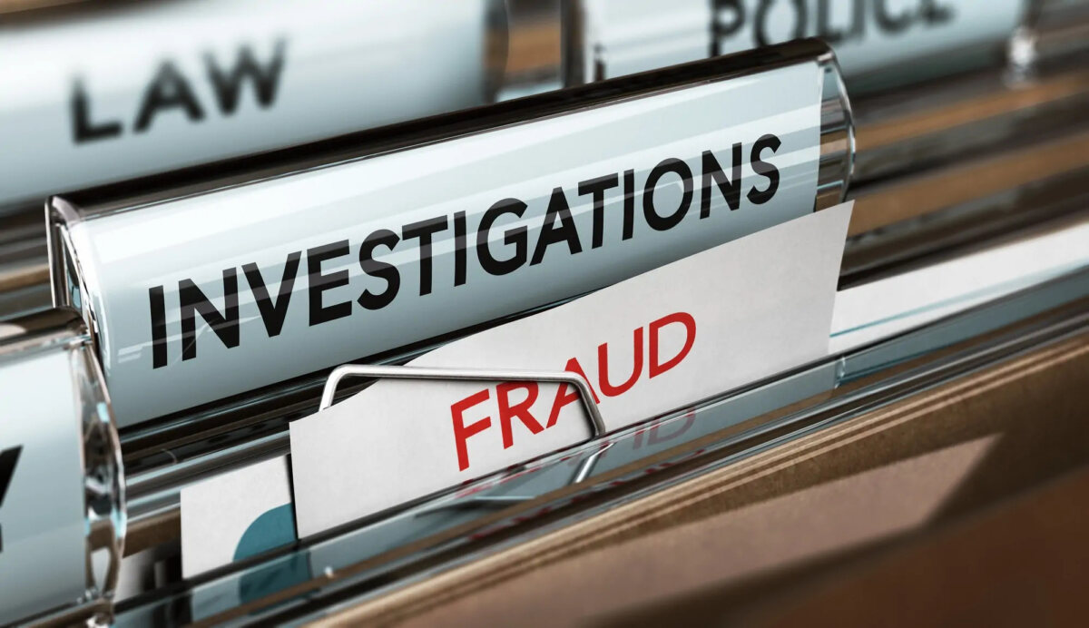 File folders with a tab labelled 'investigations' and the top of a document with the word 'fraud'