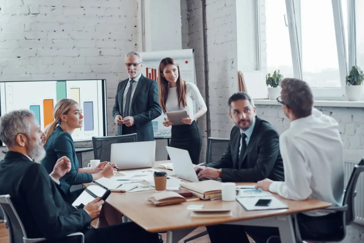 Businesspeople around table at meeting discussing business structure
