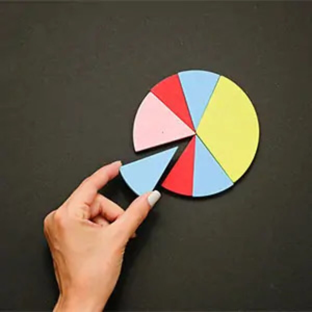 Hand placing final piece of pie chart in place