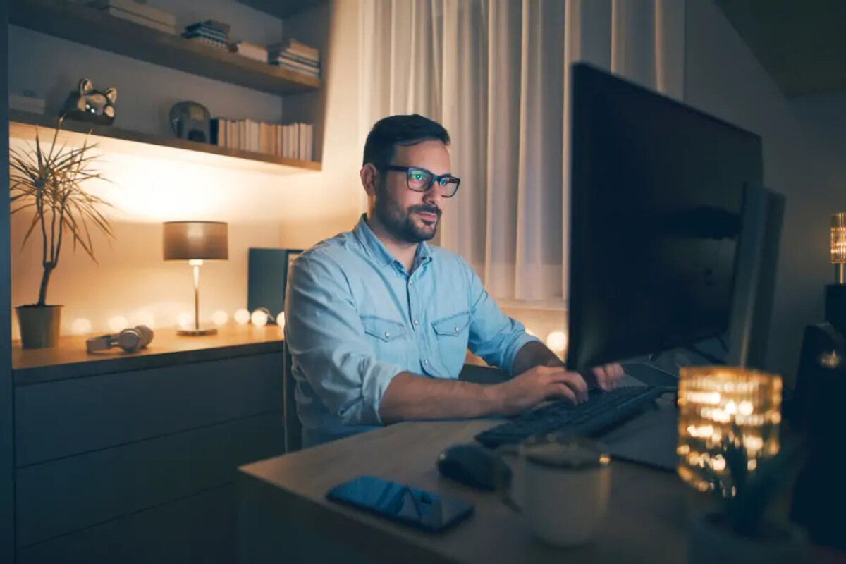 Businessman working from home at desktop in the evening