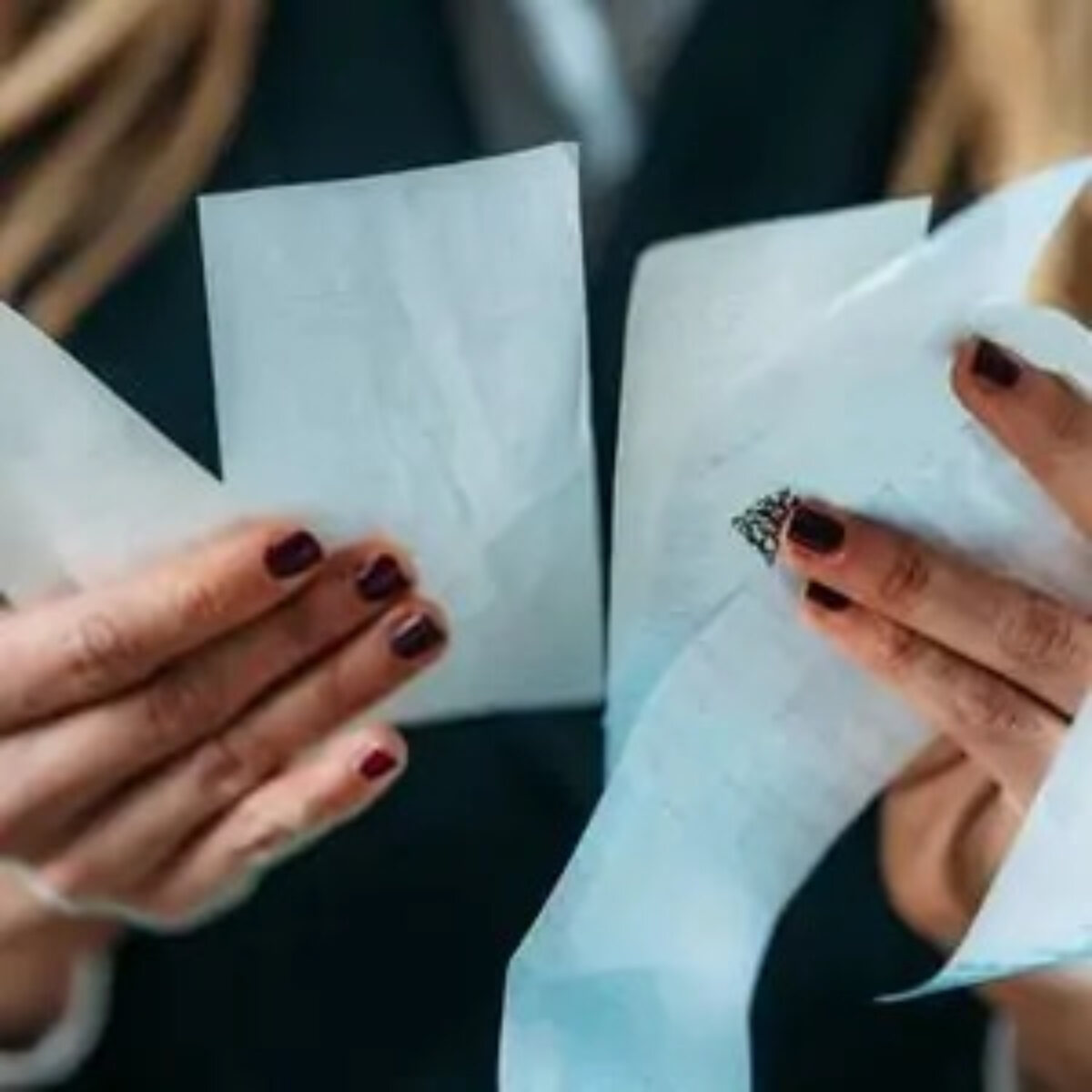 Businesswoman's hands holding receipts
