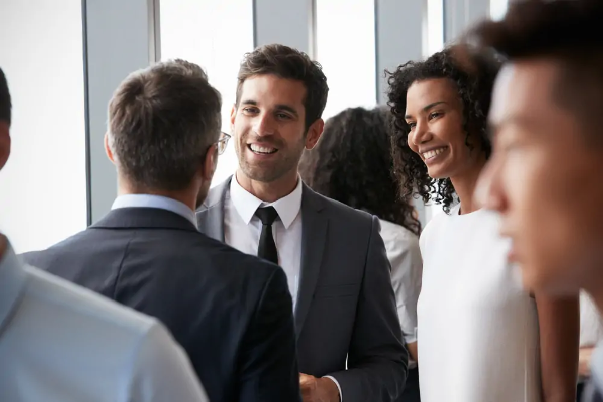 Three businesspeople chatting at a networking event