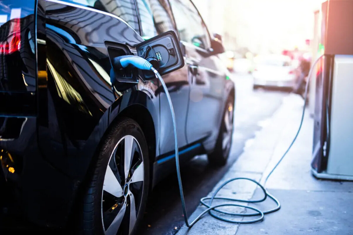Electric company car plugged in at charging point