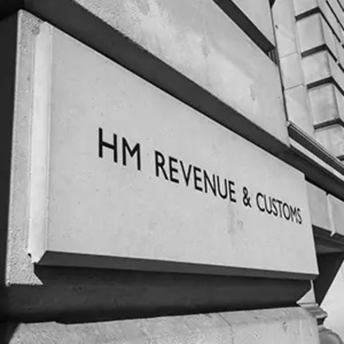 Brick of a building with 'HM REVENUE & CUSTOMS' engraved on it