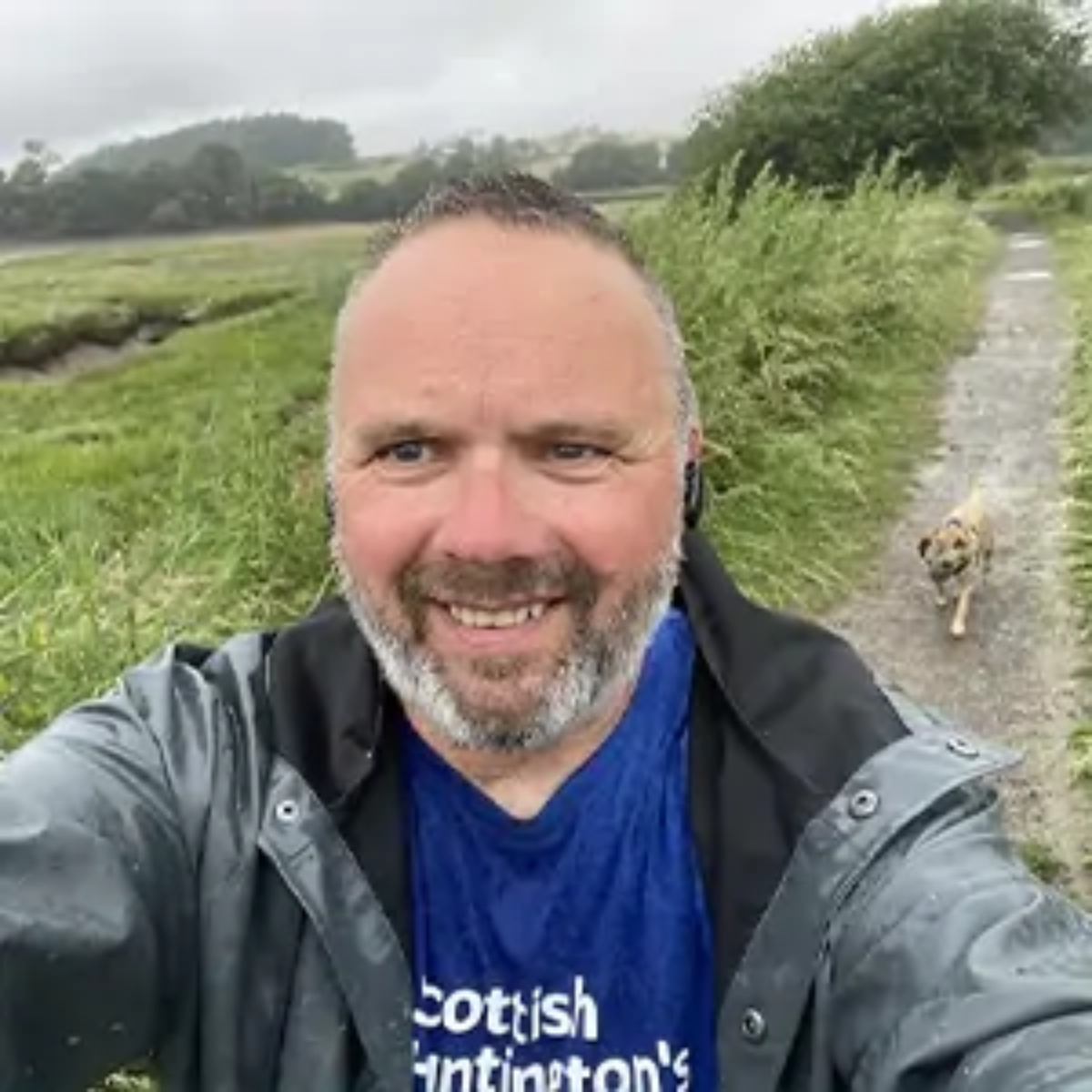 Selfie of John Moffat, CEO of Benson Wood & Co Chartered Accountants, walking with dog for charity and wearing Scottish Huntington's Association t-shirt