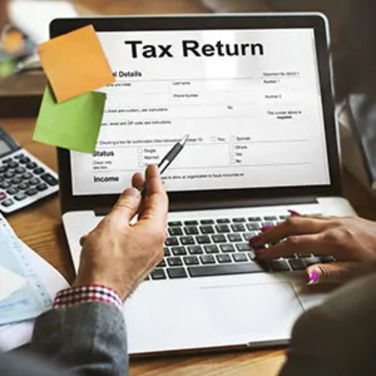 Two businesspeople filling out a tax return on laptop