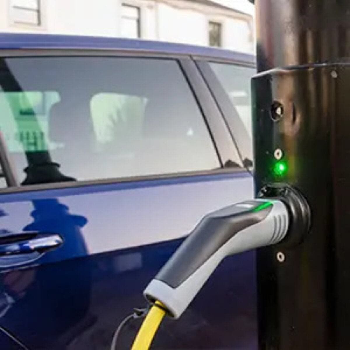 Car next to roadside electric car charging point