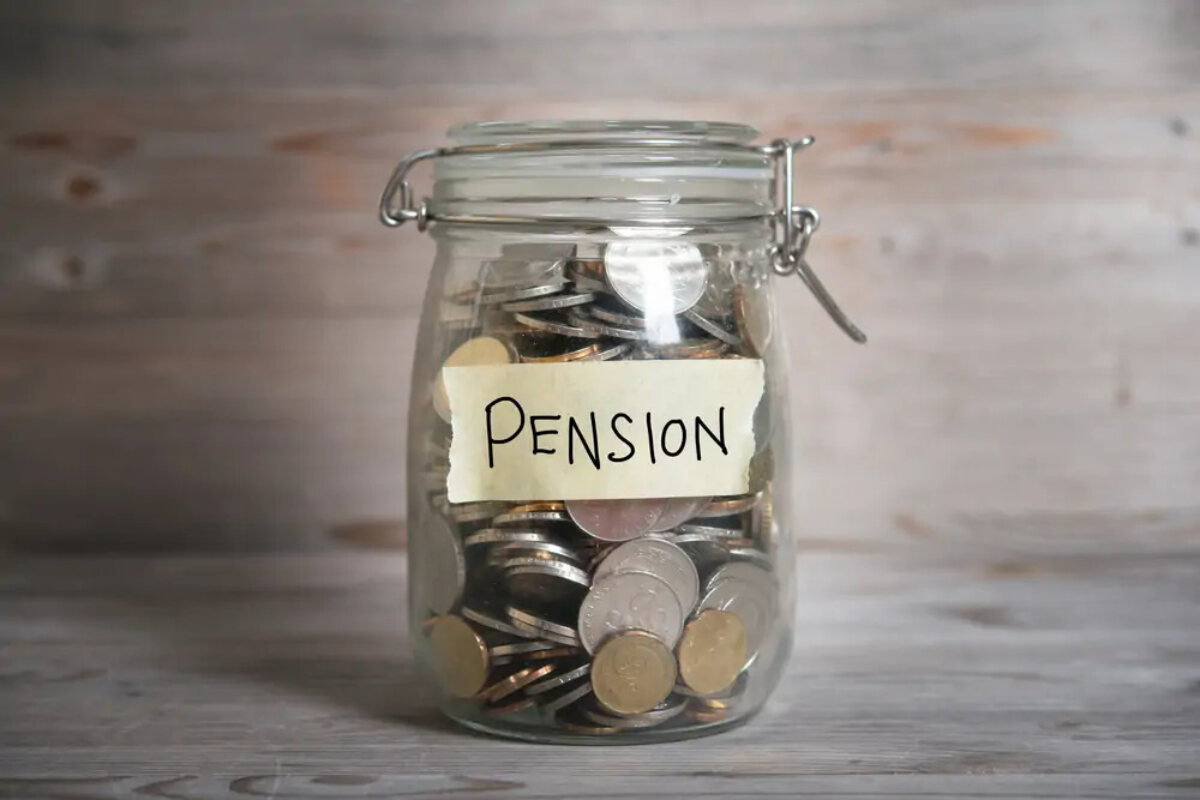 Mason jar filled with coins with 'pension' label on front
