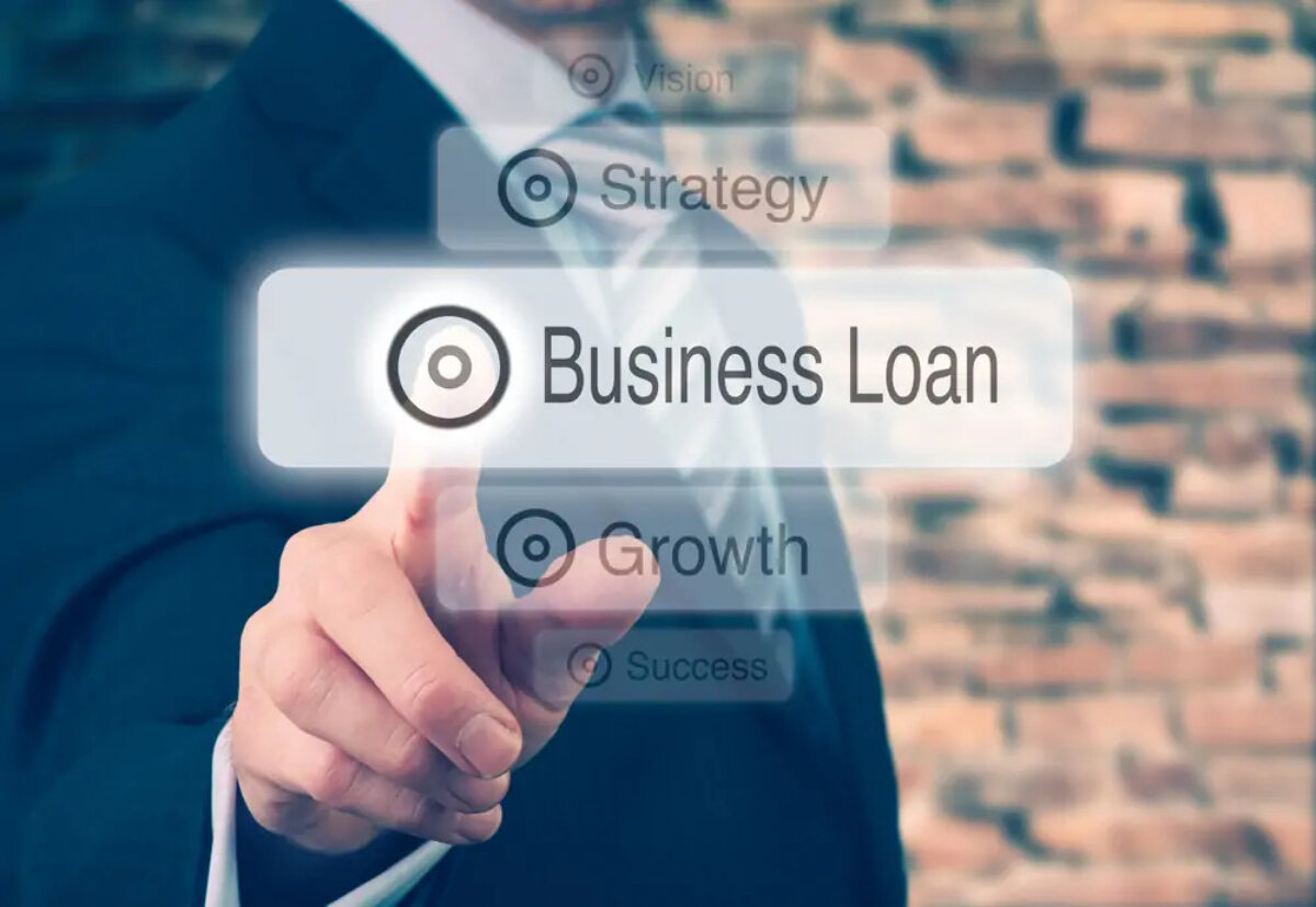 Businessman tapping image of 'business loan' button among other buttons of 'vision', 'strategy', 'growth' and 'success'