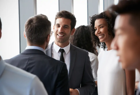 Three businesspeople chatting at a networking event