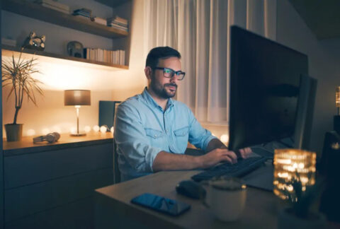 Businessman working from home at desktop in the evening