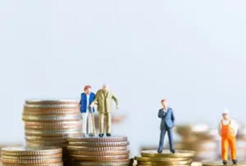 Stacks of coins of various heights with figurines on an elderly couple, a businessman and a construction worker on top