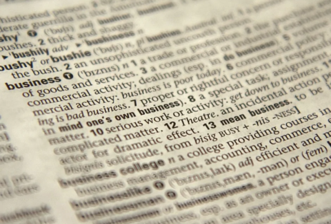 Close-up of dictionary page with definition of the word 'business'