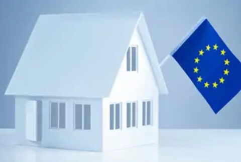 White 3D house with EU flag hanging from roof.