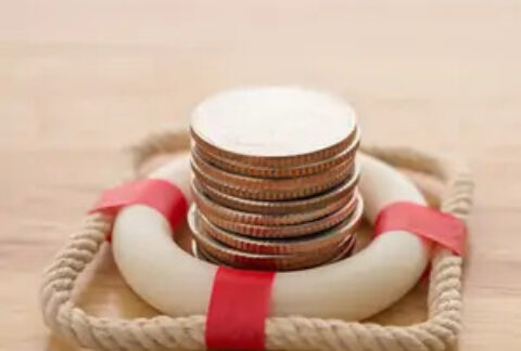 Stack of coins inside a miniature life ring