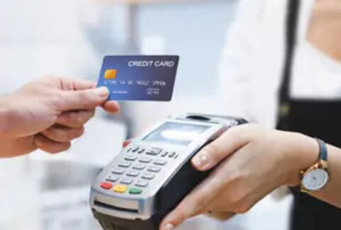 Customer using card to make contactless payment at card machine
