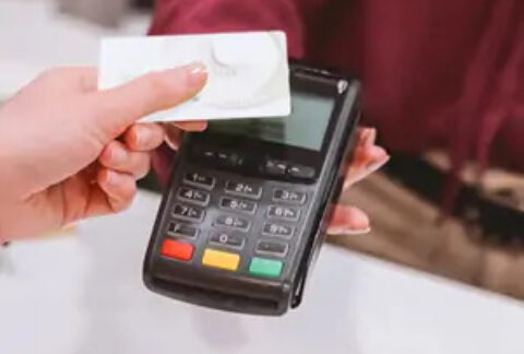 Person using card to pay contactless at card machine