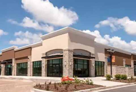 Large building with blue, cloudy sky above