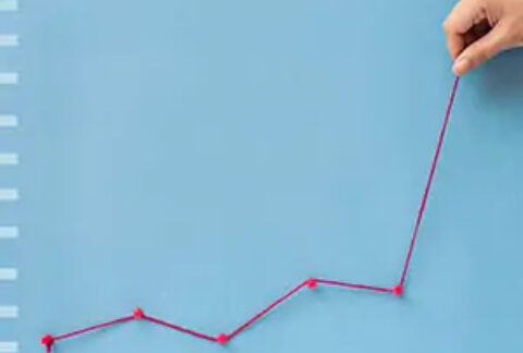 Hand making line graph from pin tacks and string
