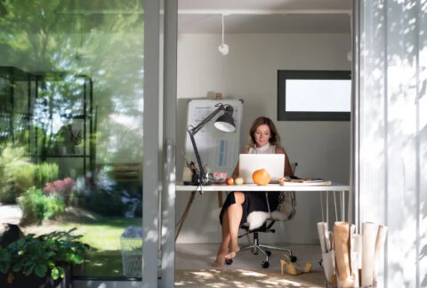 Businesswoman working from home in garden office