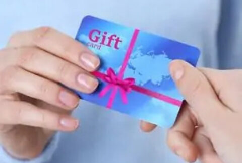 Gift card being handed over from one person to another